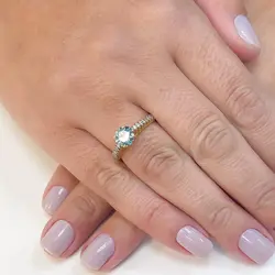 Anel Solirário de Ouro Amarelo com Diamantes Laterais e Diamante Azul Central  de 1,05 Cts.
